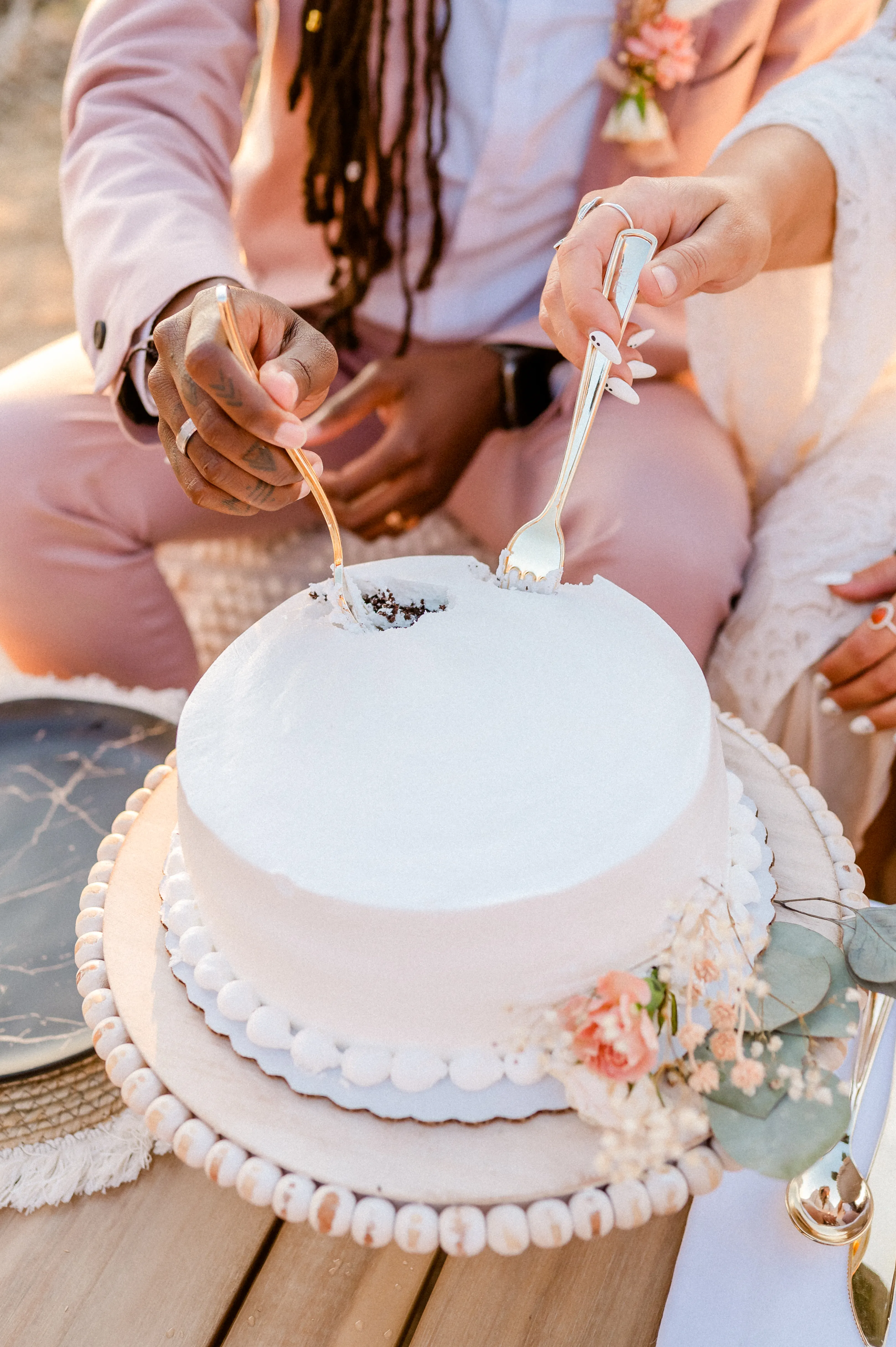 taking a bite from the wedding cake with a fork