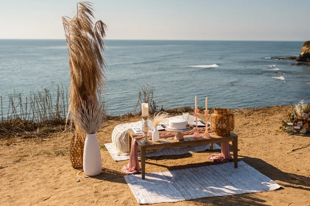 couples table on a cliff overlooking the ocean